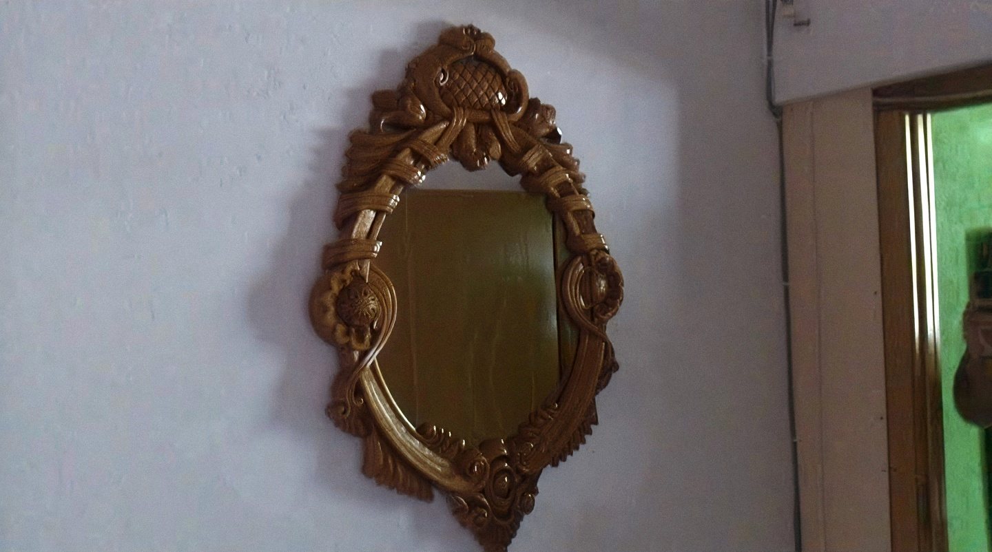 Mirror with a carved wooden frame